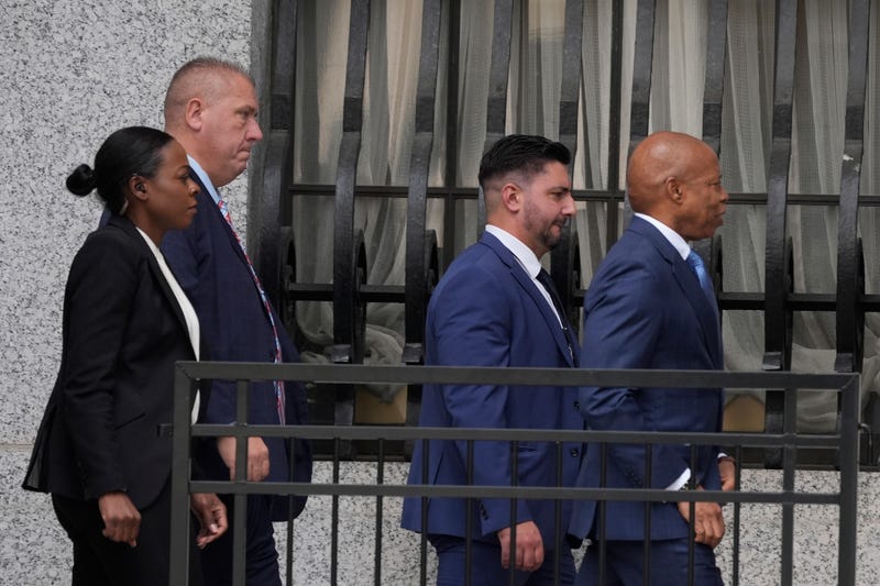 Eric Adams, right, walks into the federal courthouse in New York on Oct. 2, 2024