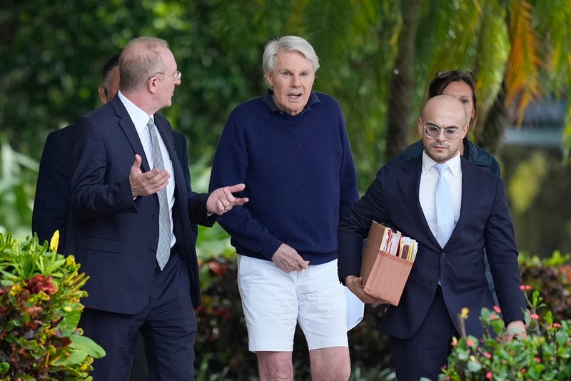 Michael Jeffries, center, former CEO of Abercrombie & Fitch, leaves with his attorney Brian Bieber, left, following a hearing at the Paul G. Rogers Federal Building and U.S. Courthouse, in West Palm Beach, Fla., on Tuesday.