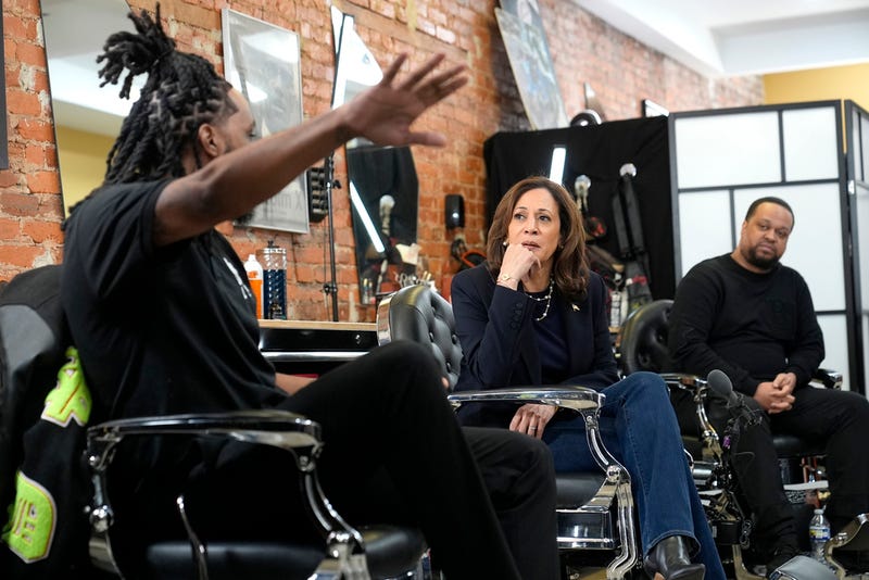Democratic presidential nominee Vice President Kamala Harris, center, sits in conversation with Black men at Philly Cutz barbershop during a campaign stop, Sunday, Oct. 27, 2024, in Philadelphia.