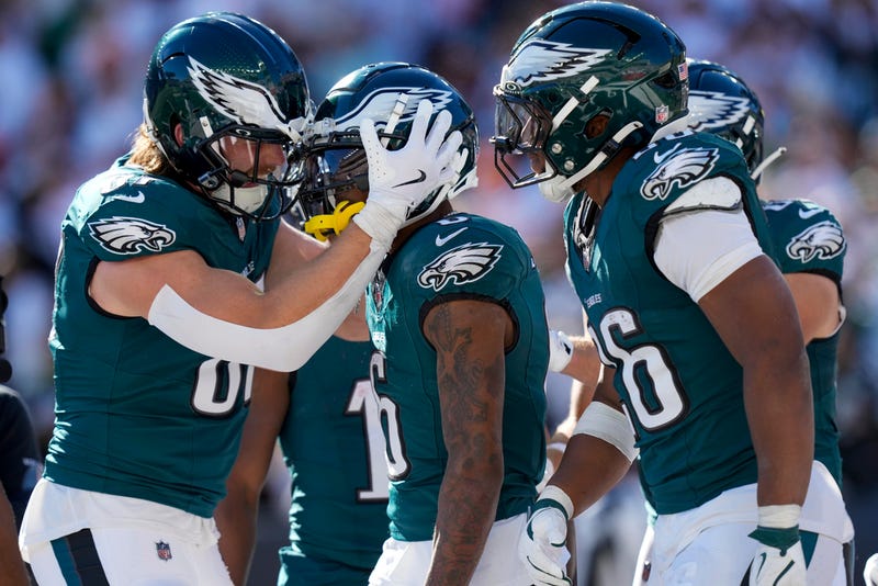 Philadelphia Eagles wide receiver DeVonta Smith, center, celebrates with teammates after catching a long touchdown pass from quarterback Jalen Hurts during the second half of an NFL football game against the Cincinnati Bengals, Sunday, Oct. 27, 2024 in Cincinnati. 