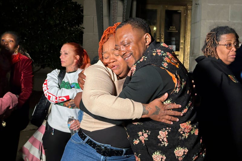 Breonna Taylor's mother, Tamika Palmer, center left, hugs a friend