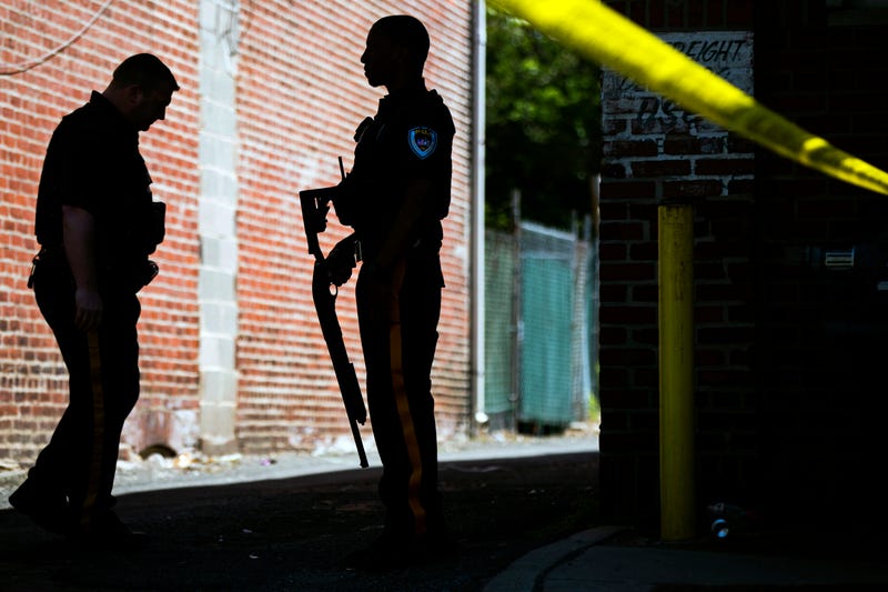 Police stand guard at the perimeter of a standoff with a man in a home in Trenton, N.J., May 10, 2017.