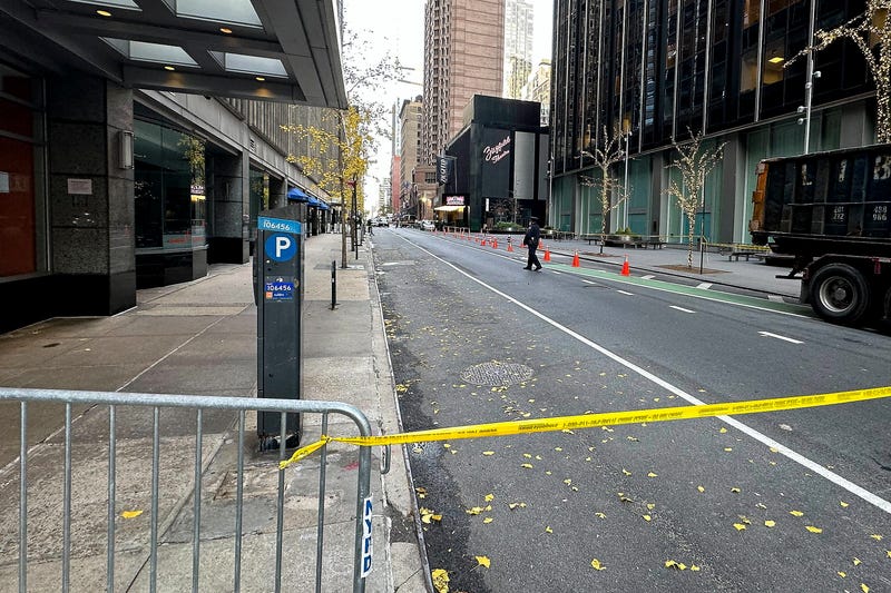 A New York police officer walks outside a hotel in midtown