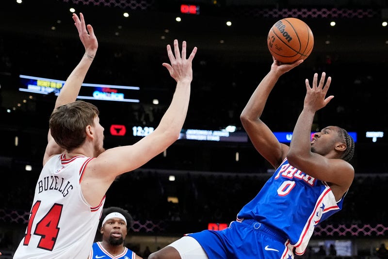 Philadelphia 76ers guard Tyrese Maxey, right, shoots over Chicago Bulls forward Matas Buzelis during the first half of an NBA basketball game in Chicago on Sunday.