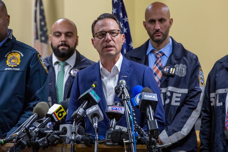 Gov. Josh Shapiro, center, speaks during a press conference regarding the arrest of suspect Luigi Mangione on Monday in Hollidaysburg, Pa.