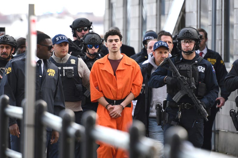 Luigi Mangione, a suspect in the fatal shooting of UnitedHealthcare CEO Brian Thompson, is escorted by police, Thursday, Dec. 19, 2024, in New York