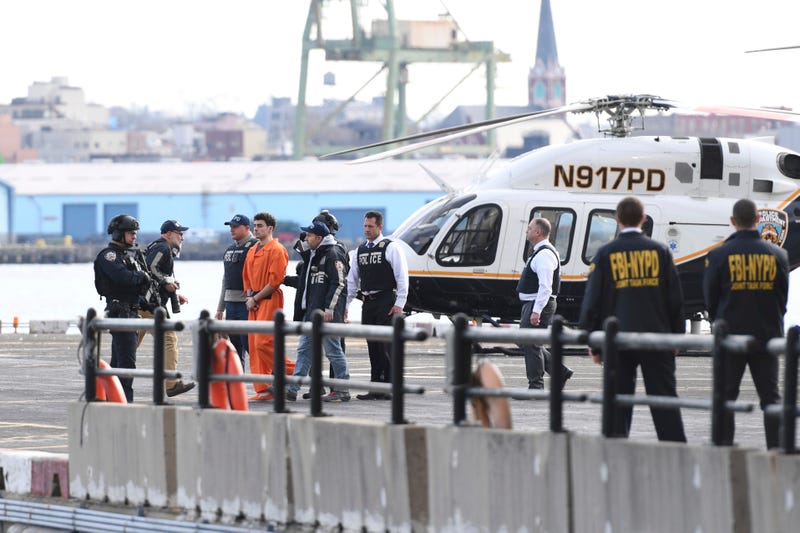 Luigi Mangione, a suspect in the fatal shooting of UnitedHealthcare CEO Brian Thompson, is escorted off of a helicopter by police, Thursday, Dec. 19, 2024, in New York
