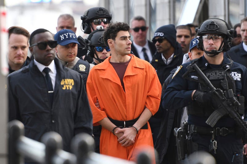 Luigi Mangione, a suspect in the fatal shooting of UnitedHealthcare CEO Brian Thompson, is escorted by police Thursday, Dec. 19, 2024, in New York