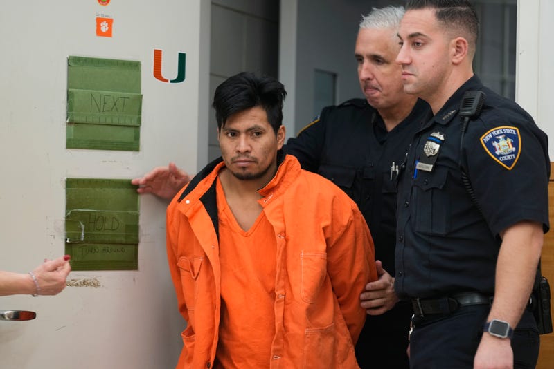 Sebastian Zapeta, accused of burning a woman to death inside a New York City subway train, left, is escorted into Kings County Supreme Court for an arraignment, Tuesday, Jan. 7, 2025, in New York