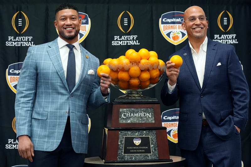 Notre Dame head coach Marcus Freeman, left, and Penn State head coach James Franklin pose with the trophy during a news conference for the Orange Bowl NCAA College Football Playoff game, Wednesday, Jan. 8, 2025, in Dania Beach, Fla. 