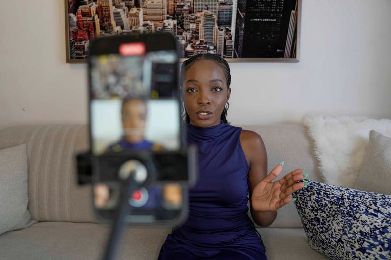 Valerie Akoko, a digital content creator, records a video for TikTok at her house in Tatu city, a startup city that tries to tackle Africa's problem of urbanizing, in Nairobi, Kenya, Friday, Oct. 25, 2024. 