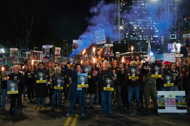 Demonstrators hold torches during a protest calling for the immediate release of the hostages held in the Gaza Strip by the Hamas militant group in Tel Aviv, Israel, on Monday, Jan. 13, 2025