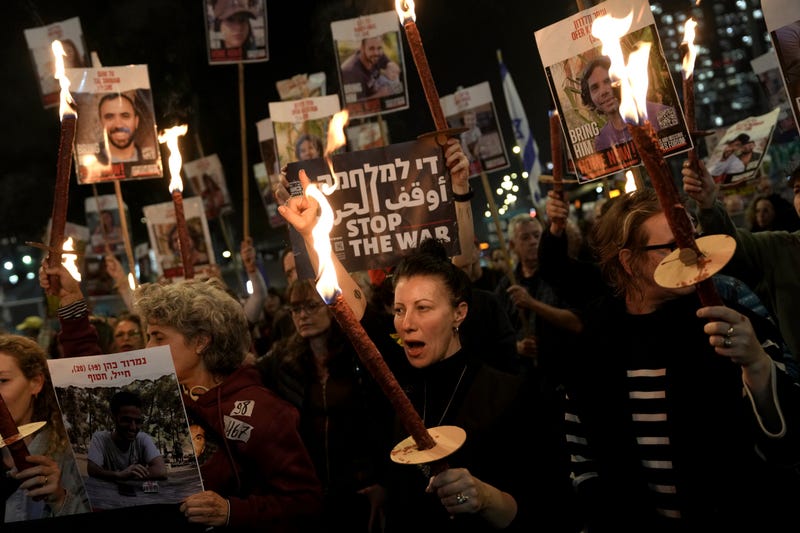 Relatives and friends of people killed and abducted by Hamas and taken into Gaza, react to the ceasefire announcement as they take part in a demonstration in Tel Aviv, Israel, Wednesday, Jan. 15, 2025