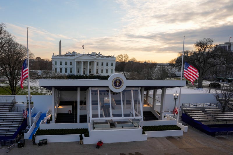 Workers continue with the finishing touches on the presidential reviewing stand .