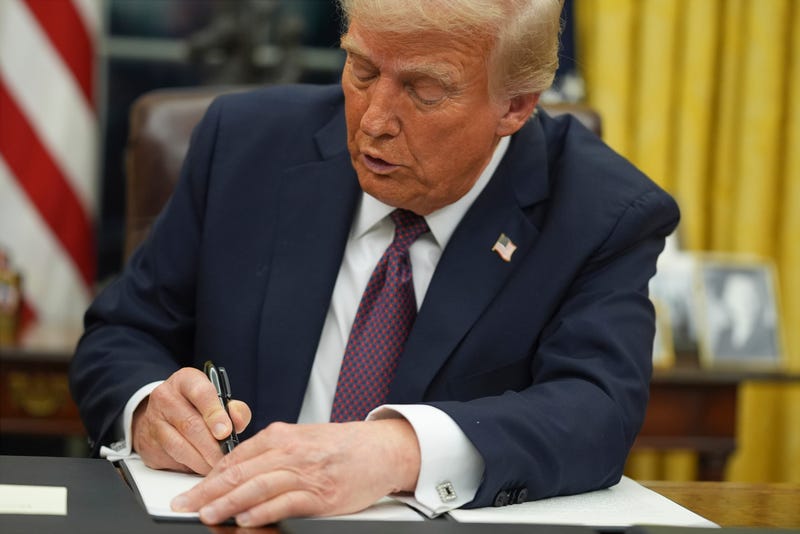 President Donald Trump signs an executive order