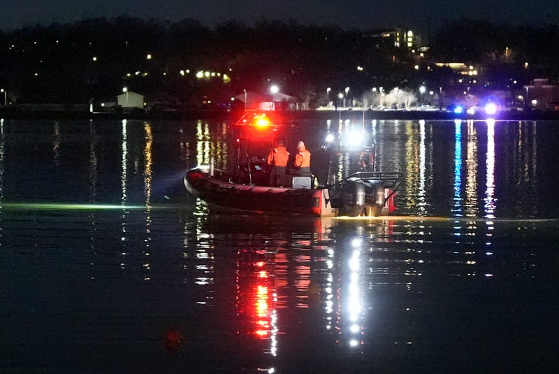 A boat works the scene near Ronald Reagan Washington National Airport, Jan. 30, 2025, in Arlington, Va.