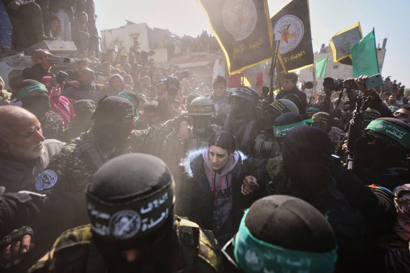 Israeli captive Arbel Yehoud, 29, who has been held hostage by Hamas in Gaza since October 7, 2023, is escorted by Hamas and Islamic Jihad fighters as she is handed over to the Red Cross in Khan Younis, southern Gaza Strip, Thursday Jan. 30, 2025