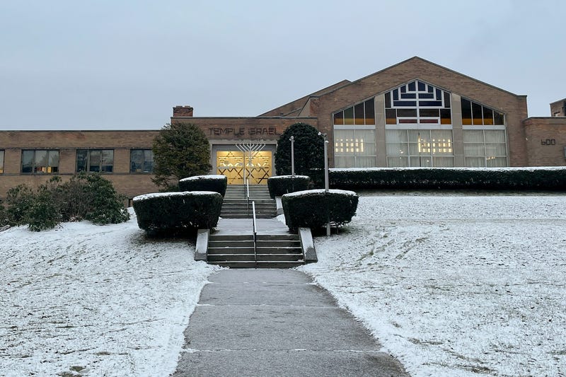 A menorah stands outside the entrance to Temple Israel, Thursday, Dec. 7, 2023, in Albany, N.Y. A 28-year-old suspect was in police custody for allegedly firing two rounds from a shotgun outside the Jewish temple on Friday, just hours before the start of Hanukkah. Officials said no one was injured and police they did not know the man's motive.