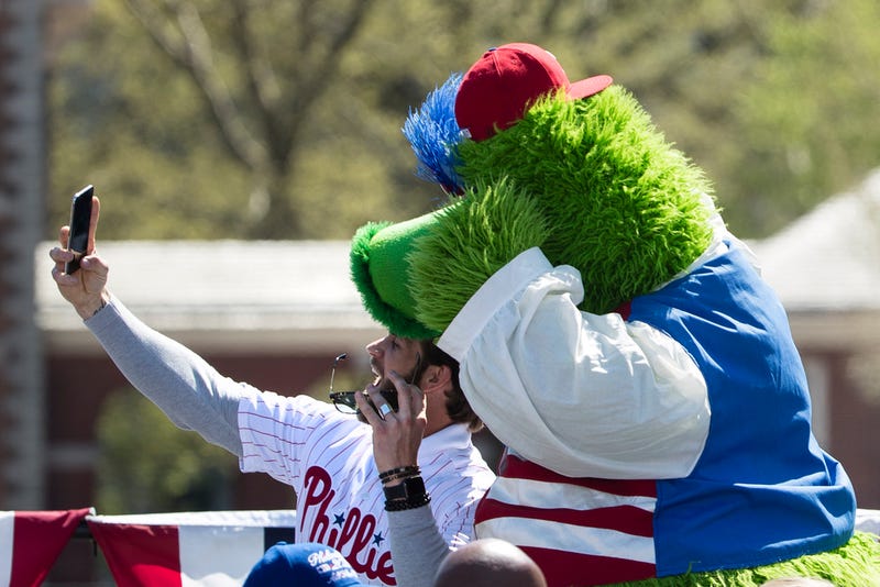Philadelphia Phillies' Bryce Harper takes a selfie with the team mascot, the Phillie Phanatic