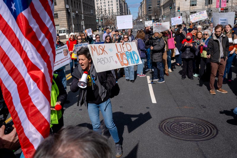 People rally on 14th St NW in support of fired USAID workers during a protest, Friday, Feb. 28, 2025, by the USAID headquarters in Washington. 