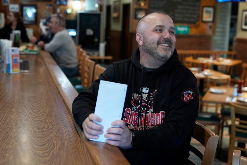 Terence Haggerty talks to customers in his family bar, Jody's Club Forest, in Staten Island, New York, March 10, 2025.