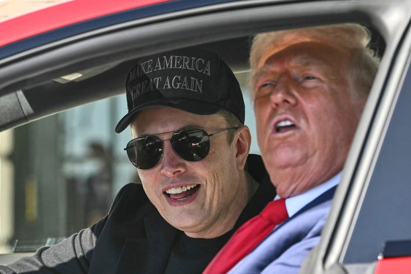 President Donald Trump and Tesla CEO Elon Musk speak to reporters as they sit in a Tesla vehicle on the South Lawn of the White House Tuesday, March 11, 2025, in Washington