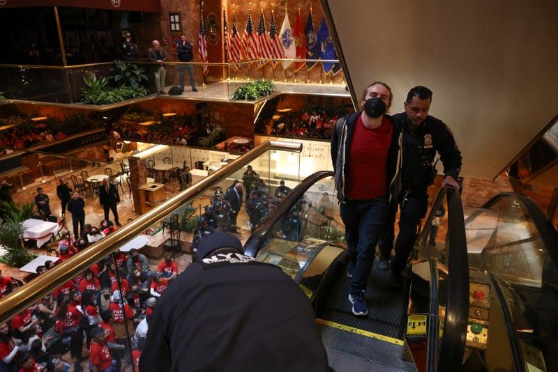 A demonstrator from the group, Jewish Voice for Peace, who protested inside Trump Tower in support of Columbia graduate student Mahmoud Khalil is escorted out by NYPD officers after being arrested, Thursday, March 13, 2025, in New York