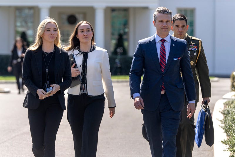 Defense Secretary Pete Hegseth, second from right, walks outside the Oval Office at the White House, Friday, March 21, 2025, in Washington. 