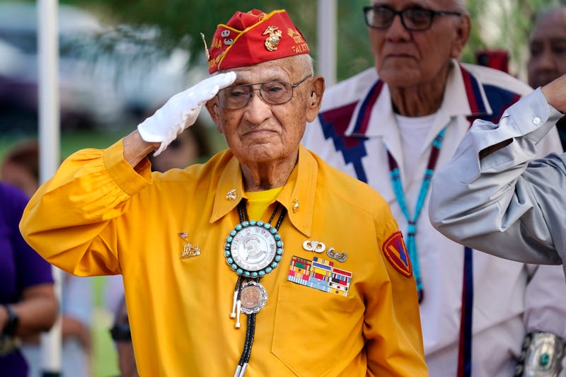 FILE - Navajo Code Talker Thomas Begay salutes during the national anthem at the Arizona State Navajo Code Talkers Day celebration, Aug. 14, 2022, in Phoenix.