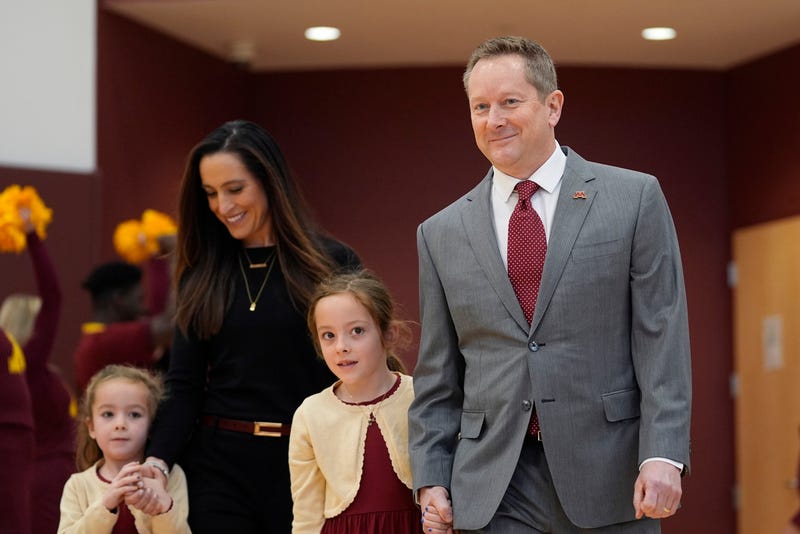 Minnesota's new head coach Niko Medved arrives with his family for an NCAA college basketball news conference, Tuesday, March 25, 2025, in Minneapolis.