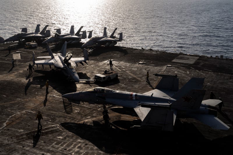 FILE - Figther jets maneuver on the deck of the USS Dwight D. Eisenhower in the Red Sea on Tuesday, June 11, 2024.