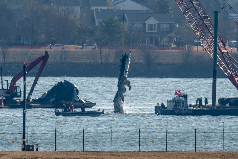FILE - A piece of wreckage is lifted from the water onto a salvage vessel near the site in the Potomac River of a mid-air collision between an American Airlines jet and a Black Hawk helicopter, at Ronald Reagan Washington National Airport, Feb. 4, 2025, in Arlington, Va.
