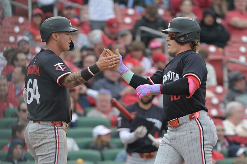 Minnesota Twins outfielder Harrison Bader (12) celebrates with Jose Miranda (64) after hitting a two-run home run during the fifth inning of a baseball game against the St. Louis Cardinals, Thursday, March 27, 2025, in St. Louis
