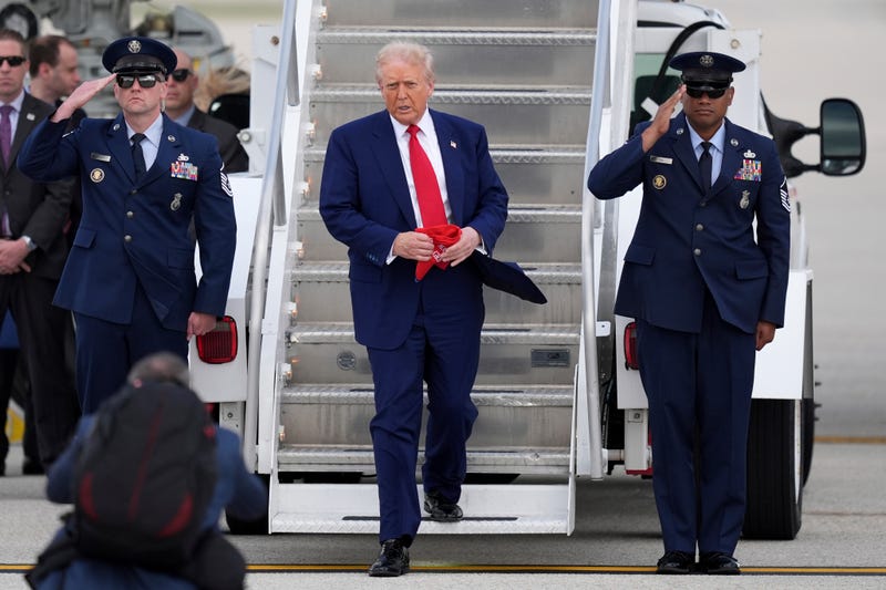 President Donald Trump, center, arrives on Air Force One at Miami International Airport, Thursday, April 3, 2025, in Miami. 