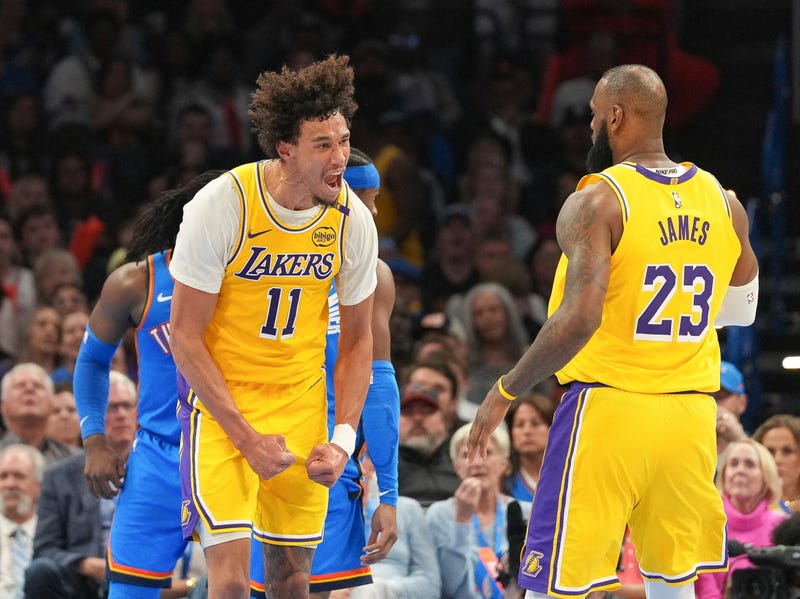 Los Angeles Lakers center Jaxson Hayes (11) celebrates with forward LeBron James (23) during the second half of an NBA basketball game against the Oklahoma City Thunder, Tuesday, April 8, 2025, in Oklahoma City. 
