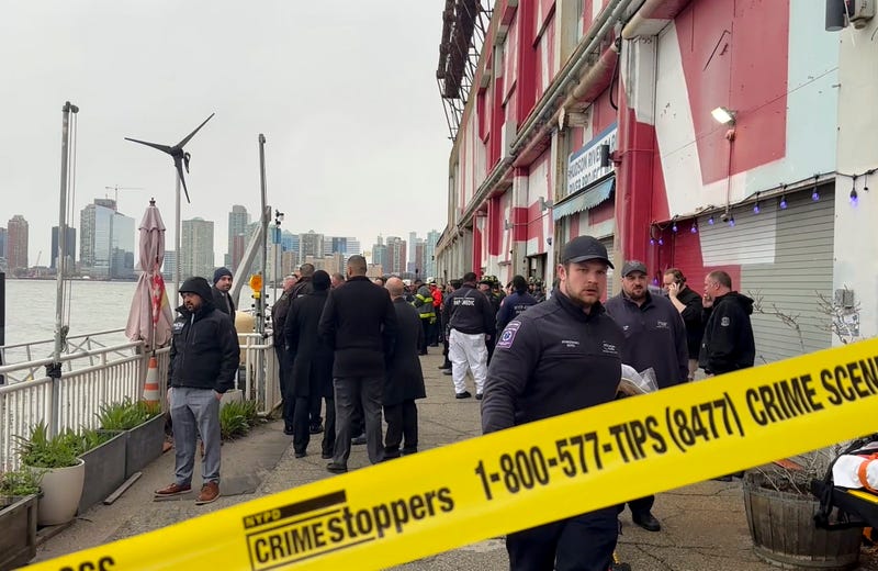 First responders walk along Pier 40, Thursday, April 10, 2025, in New York, across from where a helicopter went down in the Hudson River in Jersey City, N.J.
