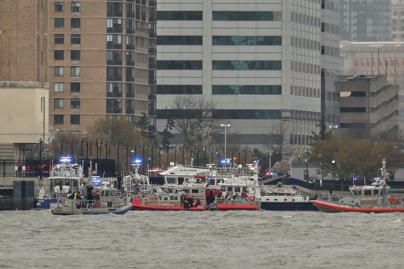As seen from Pier 40 in New York, police and fire crews from New York and New Jersey respond to the scene Thursday, April 10, 2025, where a helicopter went down in the Hudson River between Manhattan and the New Jersey waterfront.