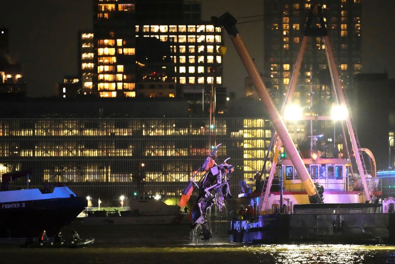 aA crane vessel lifts the wreckage of a helicopter that crashed into the Hudson River, Thursday, April 10, 2025, in Jersey City, N.J