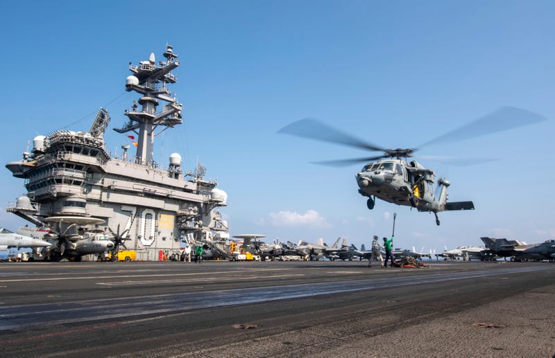 This photograph released by the U.S. Navy shows a MH-60S Sea Hawk helicopter hovering over the USS Carl Vinson aircraft carrier while operating in the Middle East on April 12, 2025.