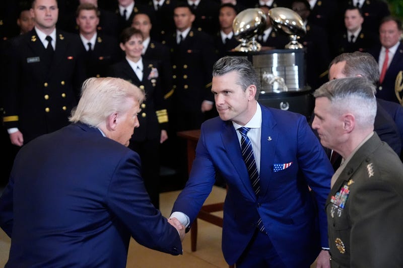 President Donald Trump shakes hands with Defense Secretary Pete Hegseth at the Commander-in-Chief trophy presentation to the Navy Midshipman football team in the East Room of the White House, Tuesday, April 15, 2025, in Washington.