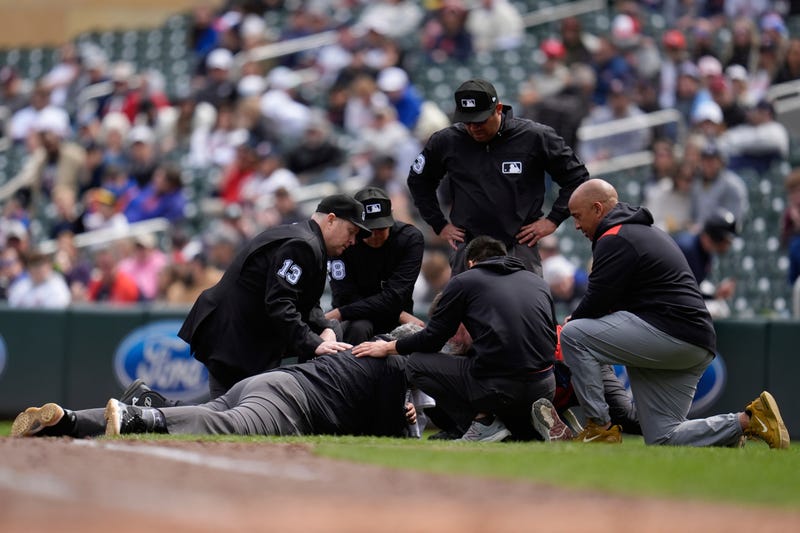 First base umpire Hunter Wendelstedt is attended to after being hit by a foul ball during the seventh inning of a baseball game between the Minnesota Twins and New York Mets, Wednesday, April 16, 2025, in Minneapolis.