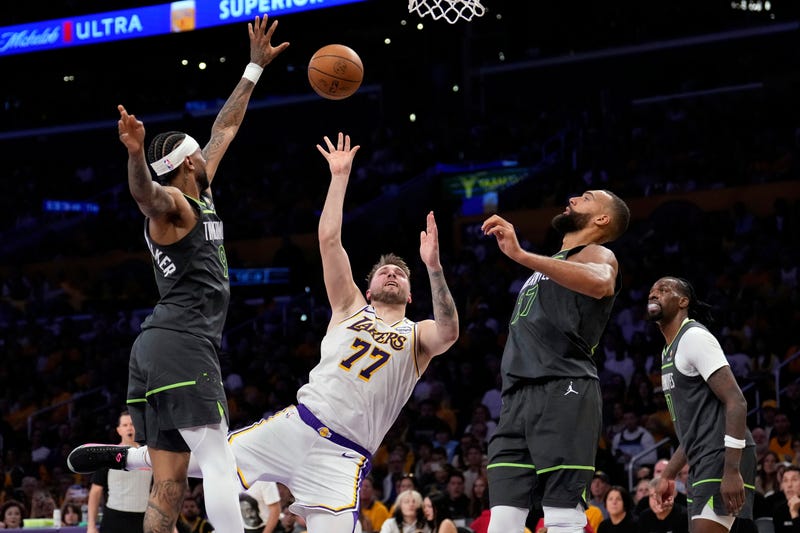 Los Angeles Lakers guard Luka Doncic (77) shoots as Minnesota Timberwolves guard Nickeil Alexander-Walker (9), center Rudy Gobert and center Naz Reid defend during the first half in Game 1 of an NBA first-round playoff series Saturday, April 19, 2025, in Los Angeles.