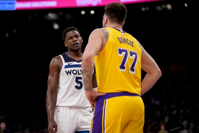 Minnesota Timberwolves guard Anthony Edwards (5) and Los Angeles Lakers guard Luka Doncic (77) interact during the first half of Game 2 of an NBA first-round playoff series in Los Angeles, Tuesday, April 22, 2025.