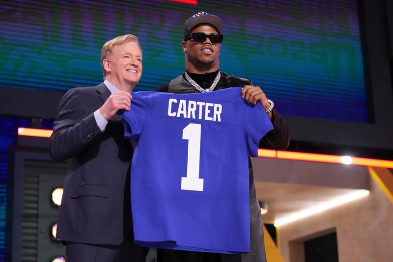 Penn State defensive end Abdul Carter, right, poses with NFL Commissioner Roger Goodell after being chosen by the New York Giants with the third overall pick during the first round of the NFL football draft, Thursday, April 24, 2025, in Green Bay, Wis. 