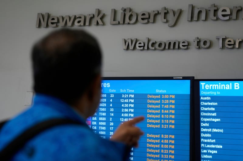 A display shows the status of flights at Newark Liberty International Airport in Newark, N.J., Monday, May 5, 2025.