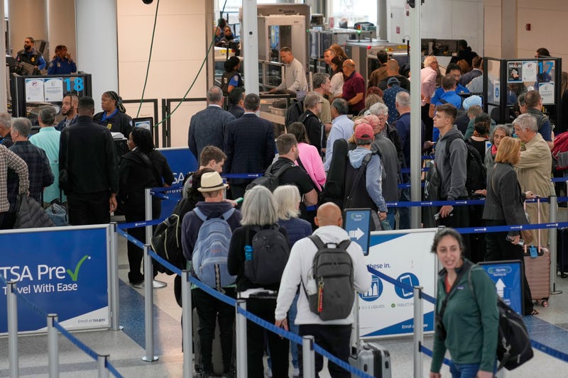 Travelers make their way through security at Newark Liberty International Airport in Newark, N.J., Monday, May 5, 2025.