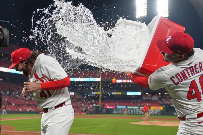 St. Louis Cardinals' Alec Burleson, left, is doused by teammate Willson Contreras following a baseball game against the Pittsburgh Pirates Tuesday, May 6, 2025, in St. Louis.