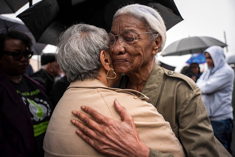 Amina Baraka, mother of Newark Mayor Ras J. Baraka, hugs Rep. Bonnie Watson Coleman, D-N.J., outside of an ICE office after her son's arrest, Friday, May 9, 2025, in Newark, N.J.