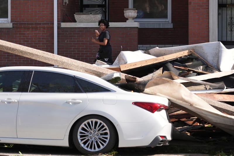 A person looks at damage caused by a severe storm moved through Friday, May 16, 2025, in St. Louis.