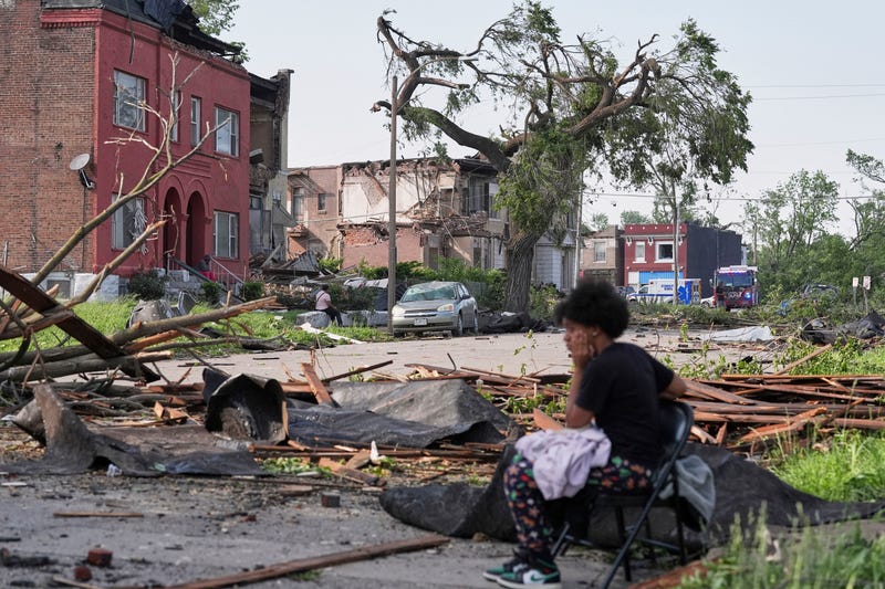 People survey damage after a severe storm moved through Friday, May 16, 2025, in St. Louis. 
